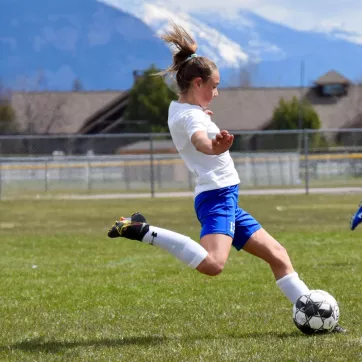 Chloe Taulbee kicks a soccer ball during a game 