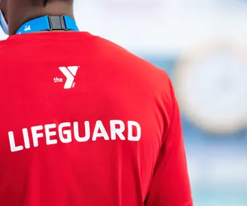 a certified lifeguard guards an indoor pool