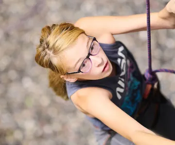 young girl climbing an indoor rock wall